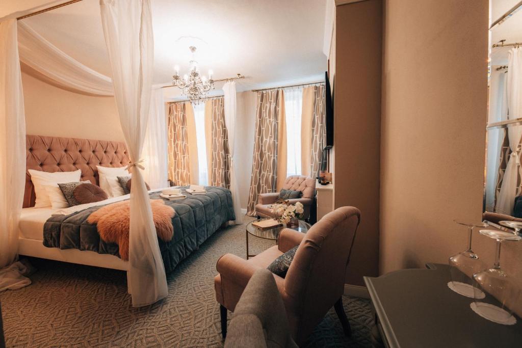 Postel nebo postele na pokoji v ubytování Hotel Telč