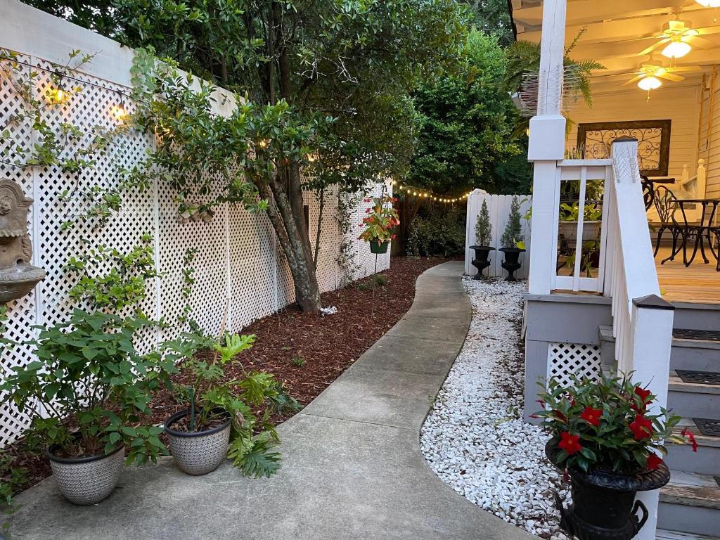 a garden with potted plants and a fence at Bama Bed and Breakfast - Chimes Suite in Tuscaloosa