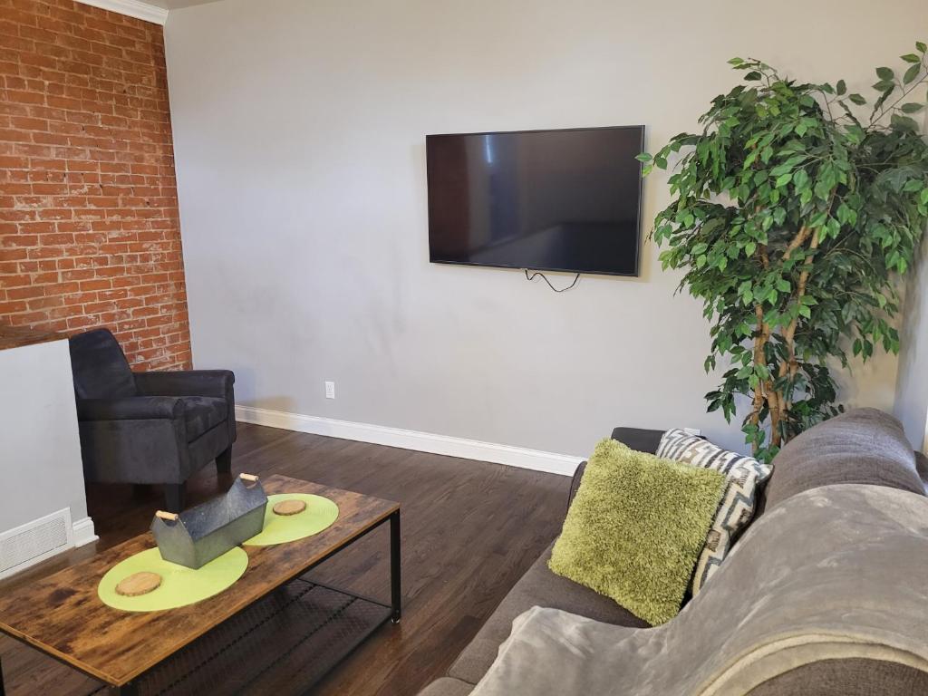 a living room with a couch and a tv at Fresh Modern Industrial split level in Cincinnati
