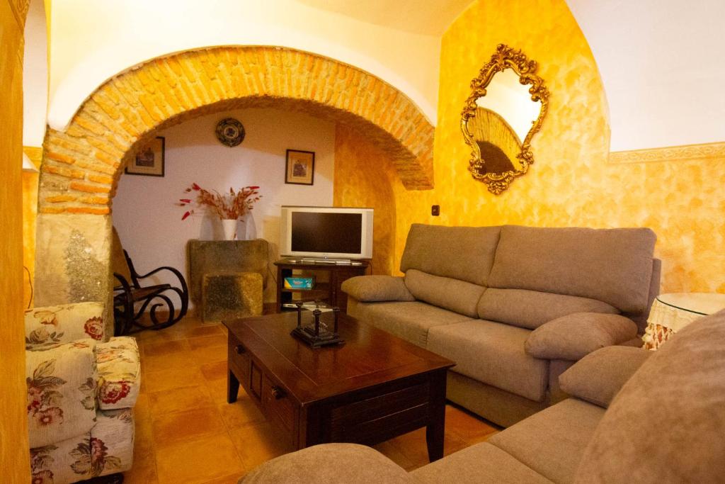 a living room with a couch and a tv at Casa Rural Villa Vieja in Botija