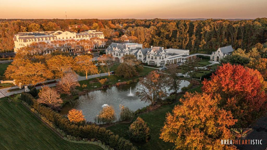 an aerial view of a large mansion with a lake at The Chateau Grande Hotel in East Brunswick