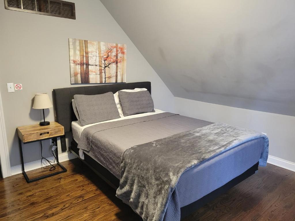 a bed with two pillows on it in a bedroom at Modern Rustic split level with balcony in Cincinnati