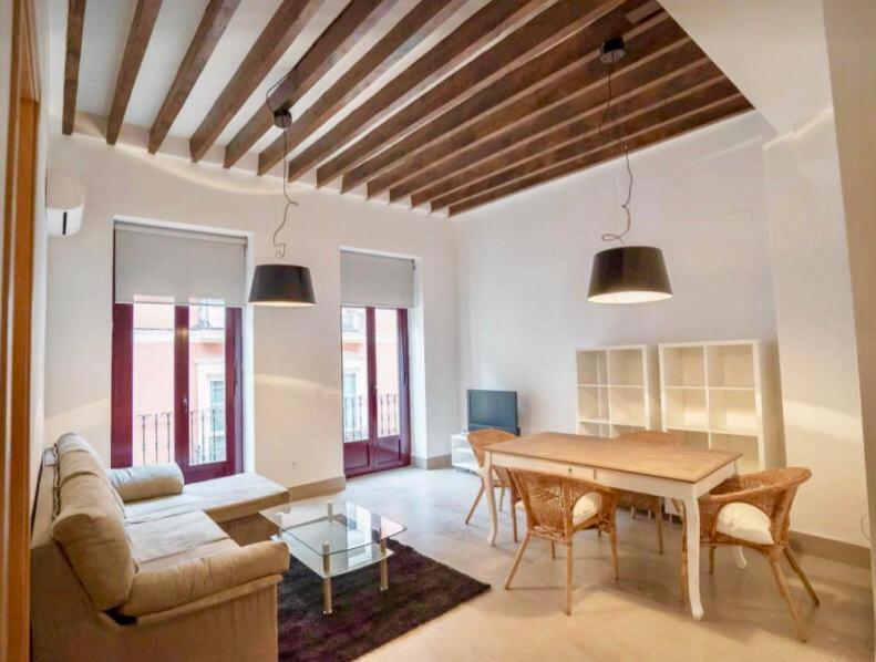 a living room with a table and a couch at LovelyLoft Castaños in Alicante