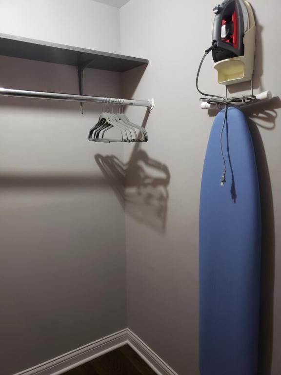 a room with a blue surfboard hanging on a wall at Modern Rustic split level with balcony in Cincinnati