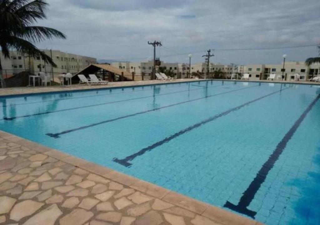 duży basen z niebieską wodą w obiekcie Condominio Residencial Marina Club w mieście São Pedro da Aldeia