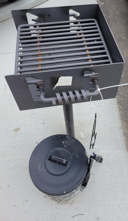 a grill sitting on top of a sidewalk at Modern Rustic split level with balcony in Cincinnati