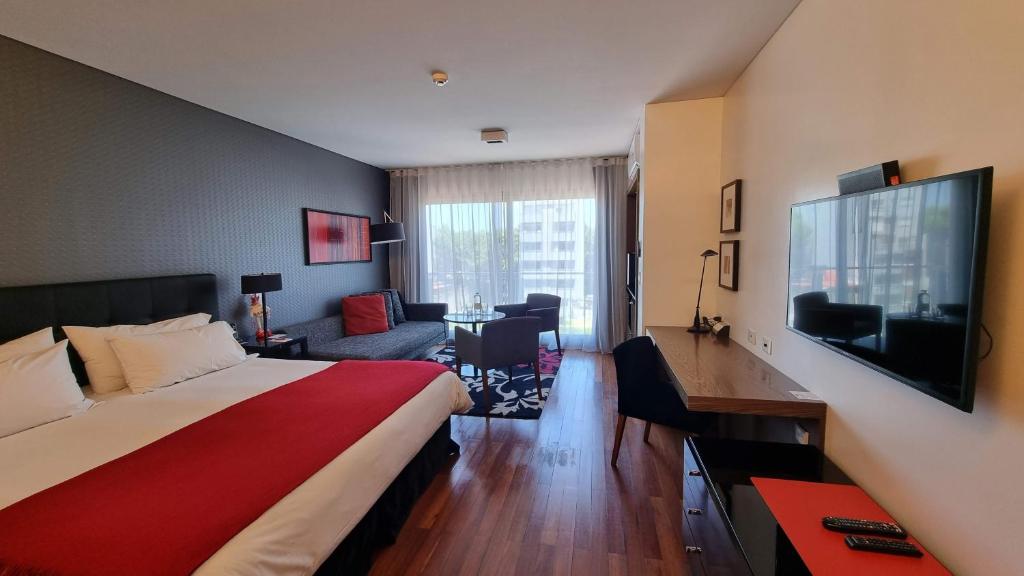 a hotel room with two beds and a television at Fierro Hotel Buenos Aires in Buenos Aires