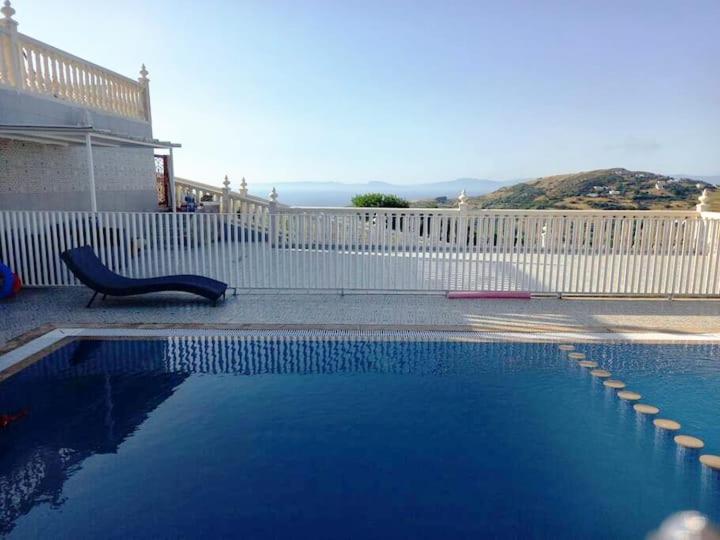 a swimming pool in front of a white fence at Villa Overlooking Beach - Private Swimming Pool! in Tangier