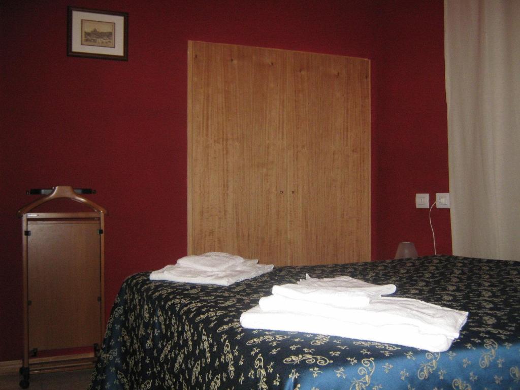 Postel nebo postele na pokoji v ubytování Hotel Ferraro