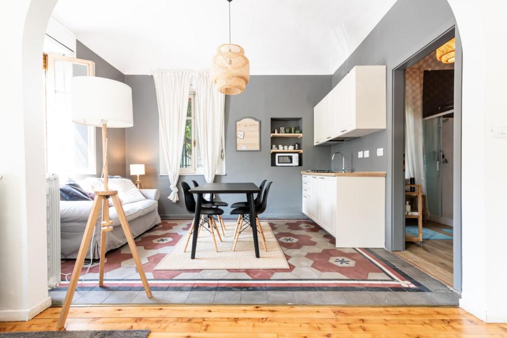 a living room with a table and a kitchen at The Nice Place “La Casetta” in Turin