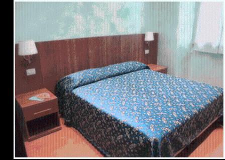 Postel nebo postele na pokoji v ubytování Hotel Ferraro
