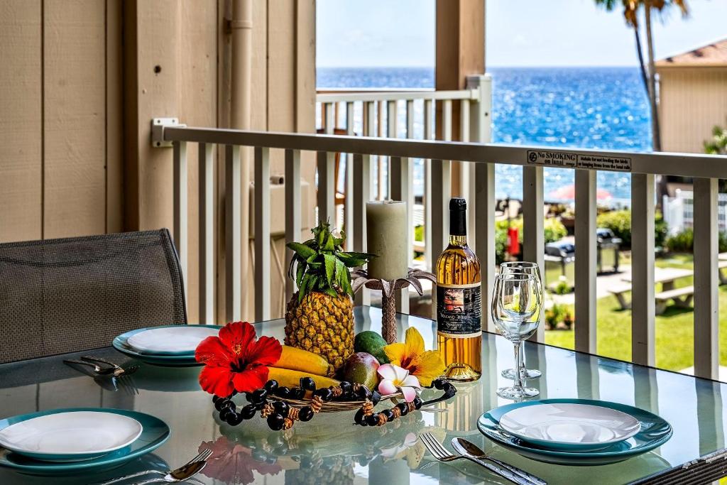 a table with a pineapple and other food on it at Sea Village #3-203 in Kailua-Kona