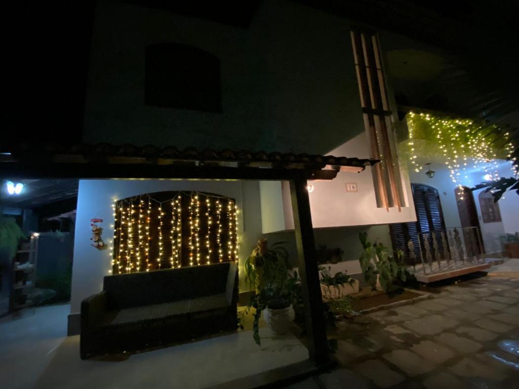 a living room with a couch and christmas lights at Casa da Coruja in Rio de Janeiro