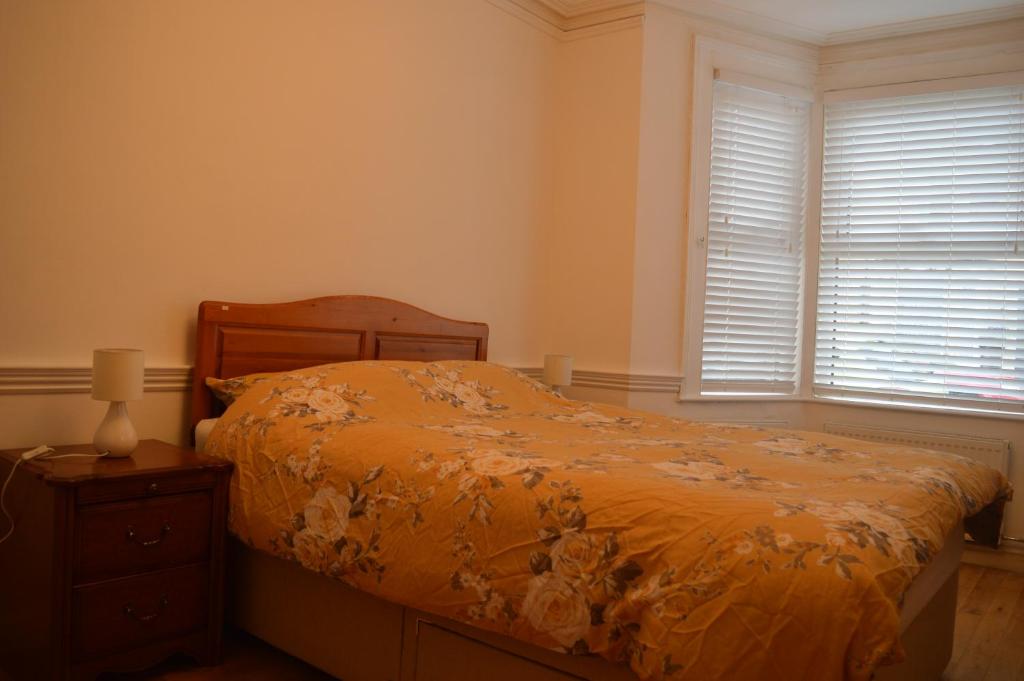 a bedroom with a bed and a dresser and a window at The Crandale Road House in Bath