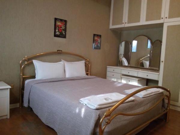 a bedroom with a large bed and a mirror at La Bella Venezia in Mestre