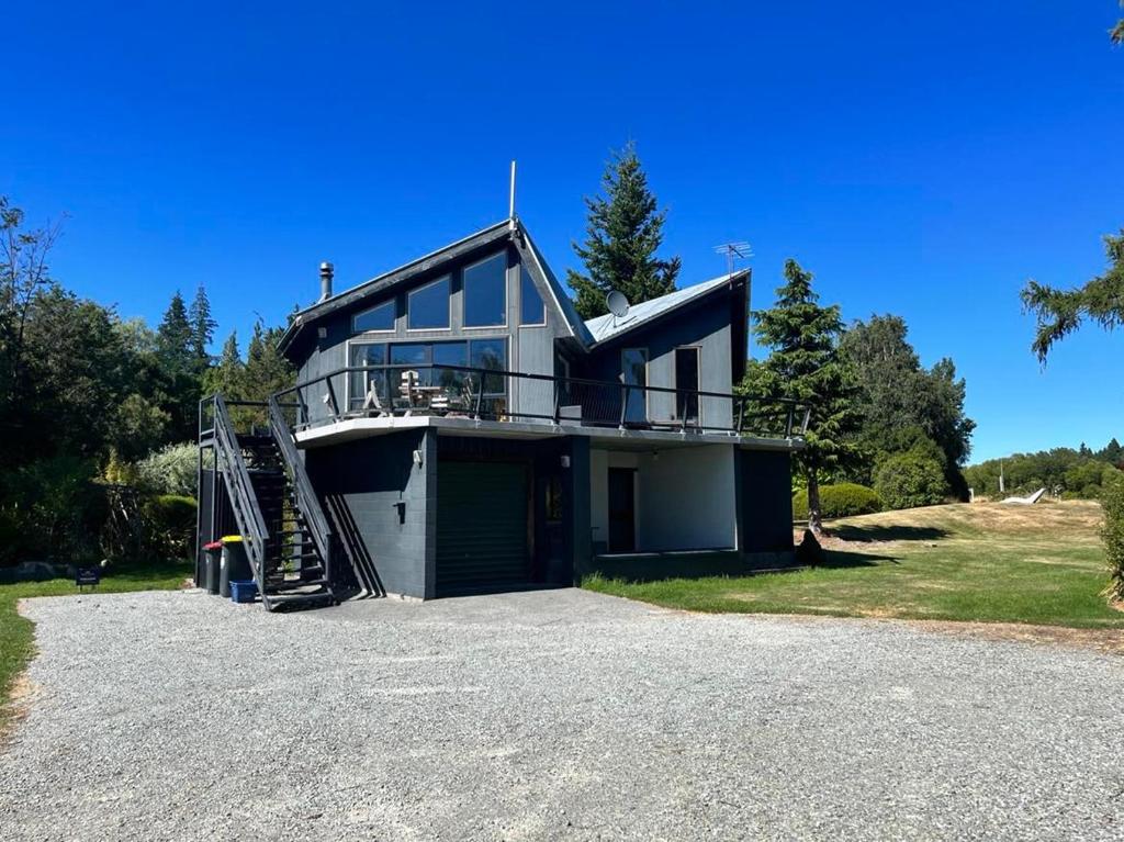 a house on a hill with a driveway at Opera House Beside the Lake in Lake Tekapo