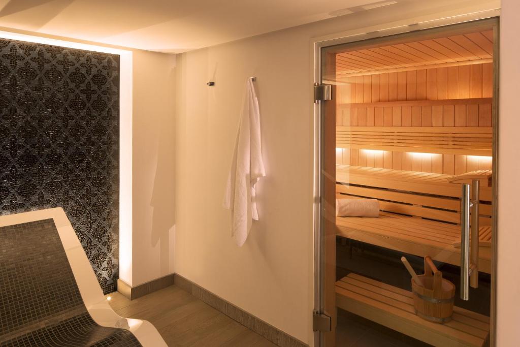 a room with a sauna with a chair in it at Hotel D - Strasbourg in Strasbourg