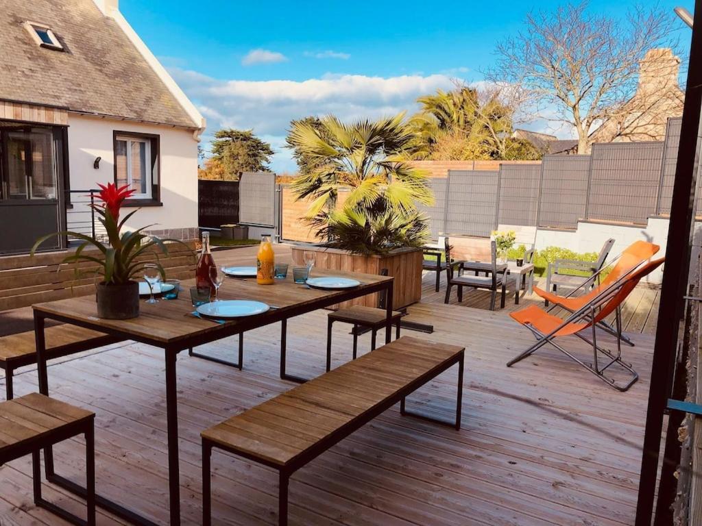 a patio with tables and chairs on a deck at Comfortable holiday home with a spacious terrace area near the sea in Sibiril