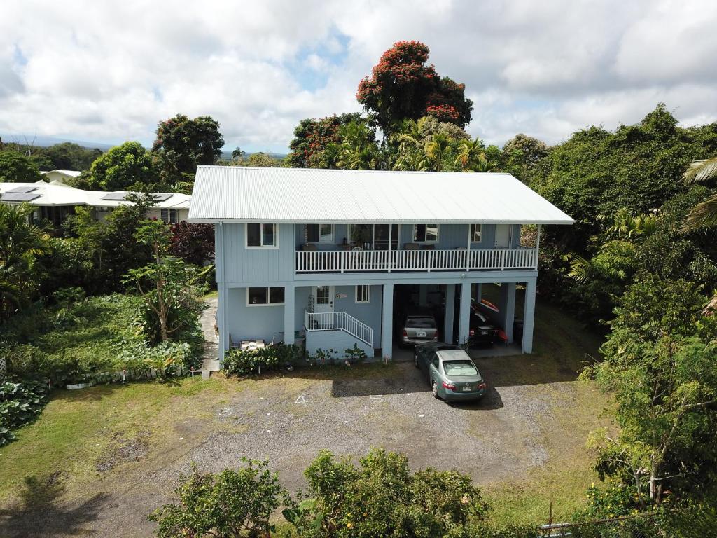 an aerial view of a blue house with a car at Hawaiian Ohana Home in Hilo