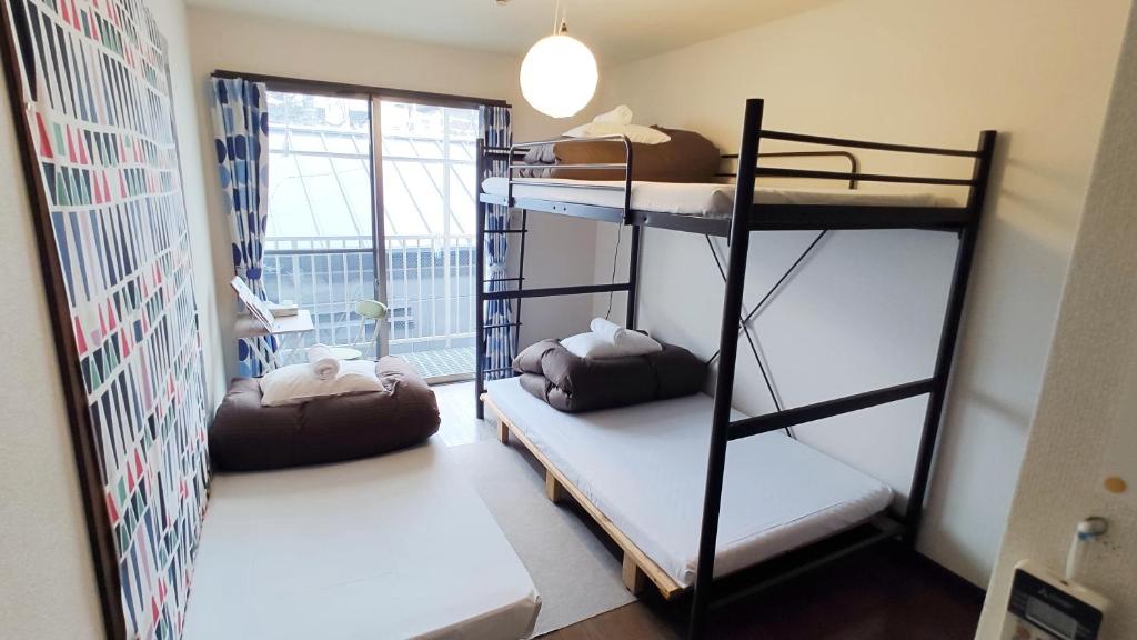Postel nebo postele na pokoji v ubytování ゲストハウスTSUU小田原 Guest House Tsuu Odawara #OD1
