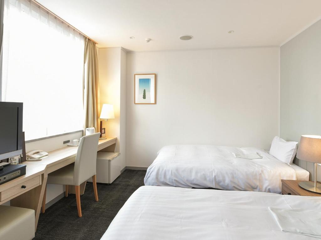 Postel nebo postele na pokoji v ubytování Hotel Iidaya