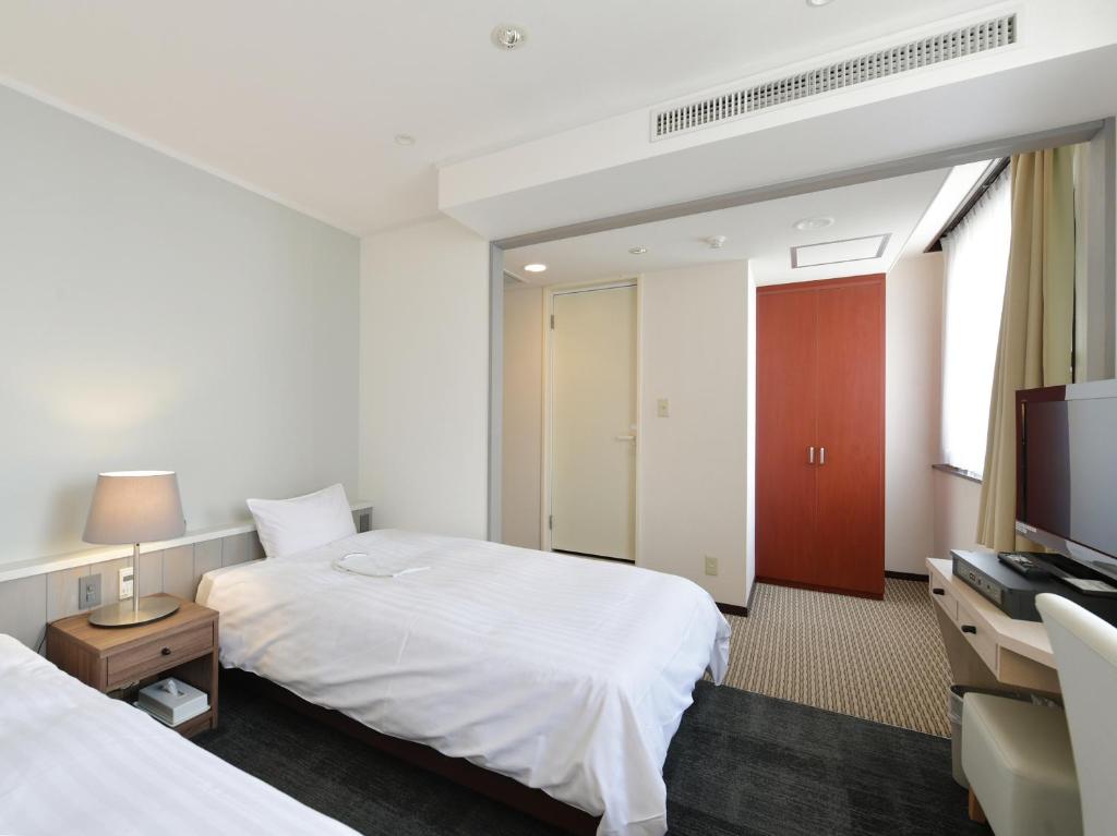 Postel nebo postele na pokoji v ubytování Hotel Iidaya
