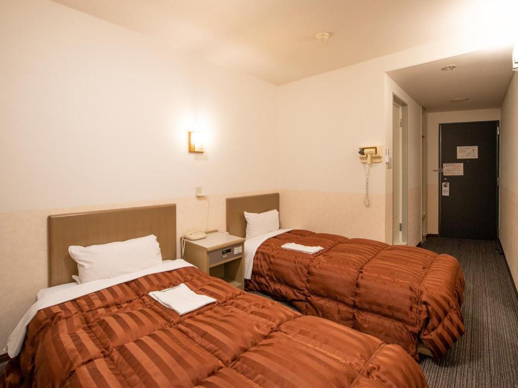 Postel nebo postele na pokoji v ubytování Hotel Iidaya