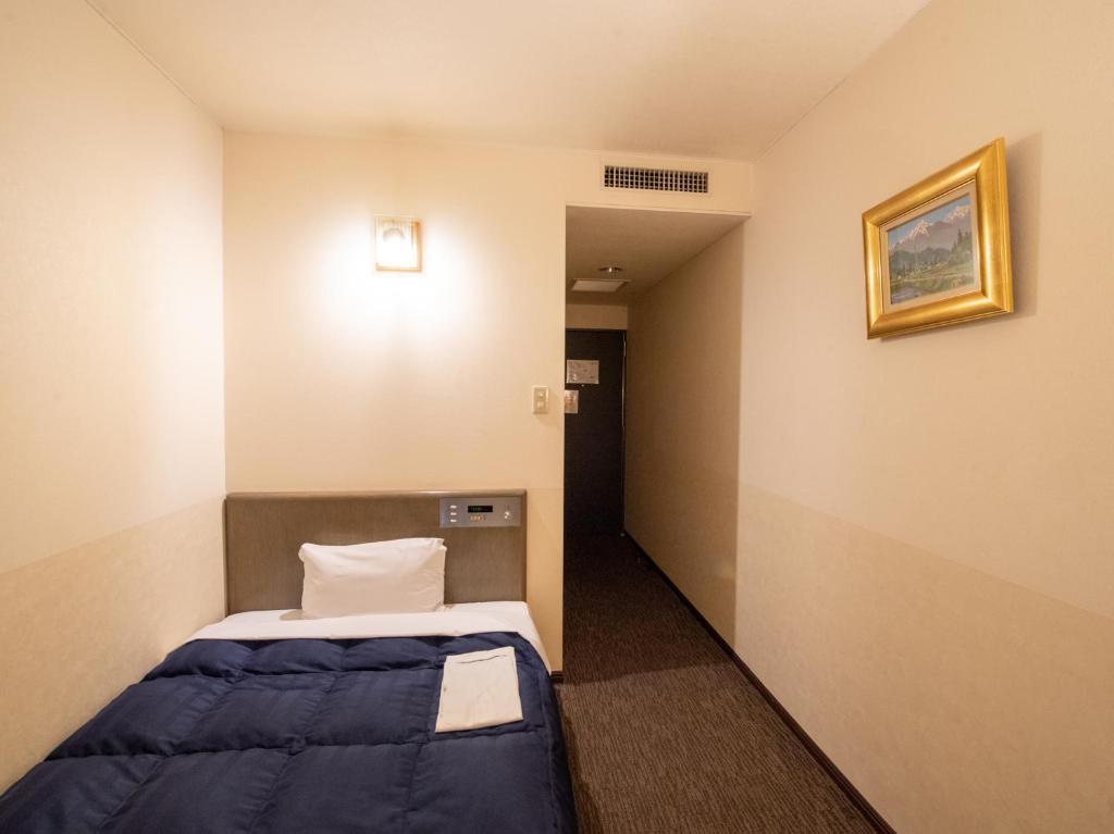 Postel nebo postele na pokoji v ubytování Hotel Iidaya