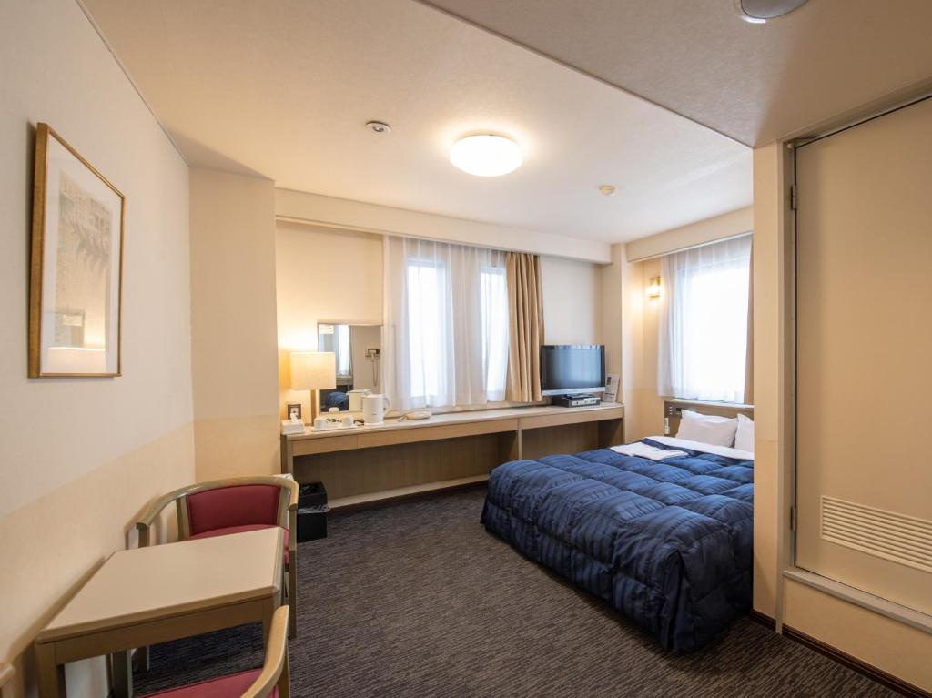 Postel nebo postele na pokoji v ubytování Hotel Iidaya