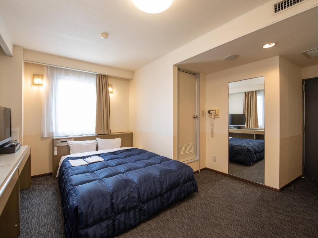 Postel nebo postele na pokoji v ubytování Hotel Iidaya