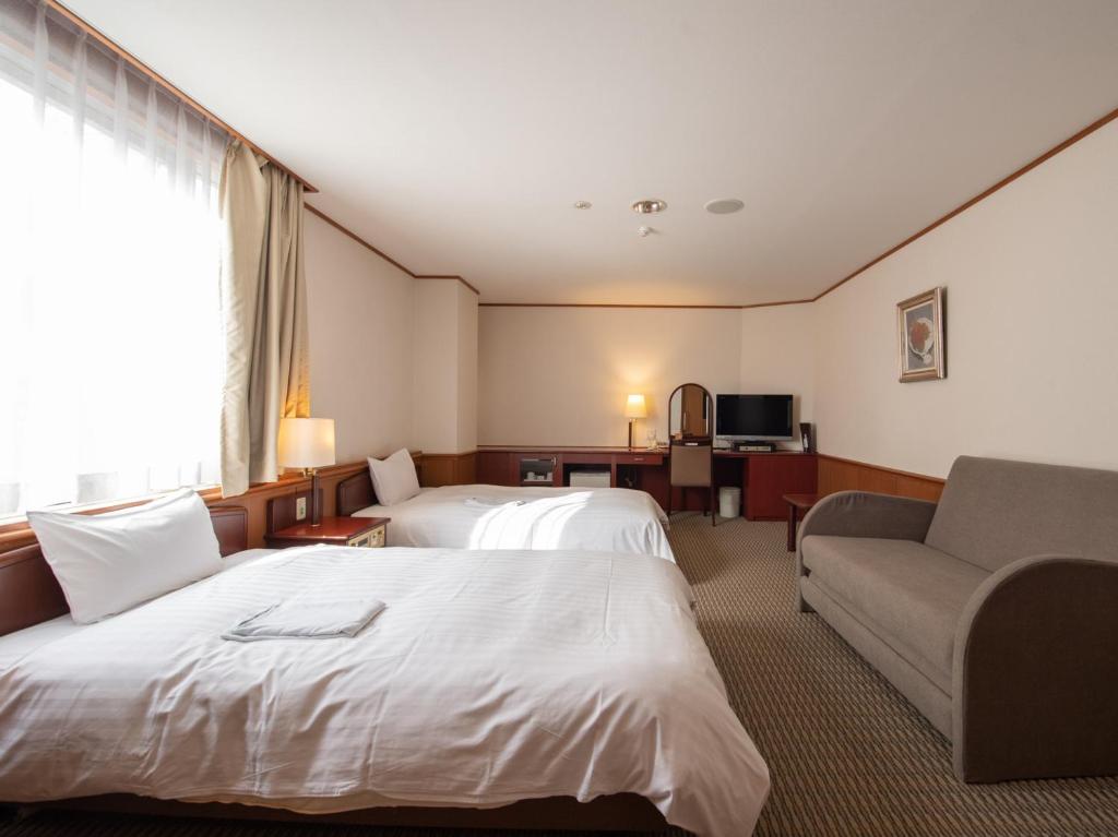 Postel nebo postele na pokoji v ubytování Hotel Iidaya