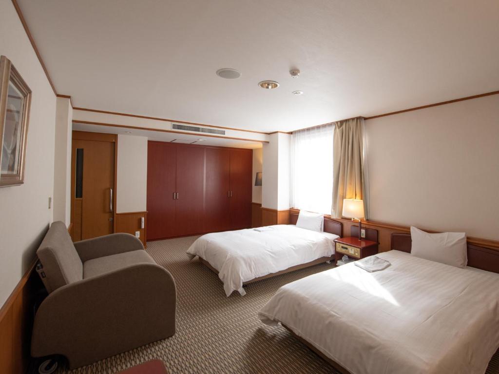 Postel nebo postele na pokoji v ubytování Hotel Iidaya