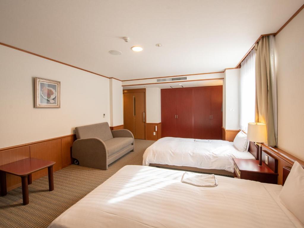 Postel nebo postele na pokoji v ubytování Hotel Iidaya