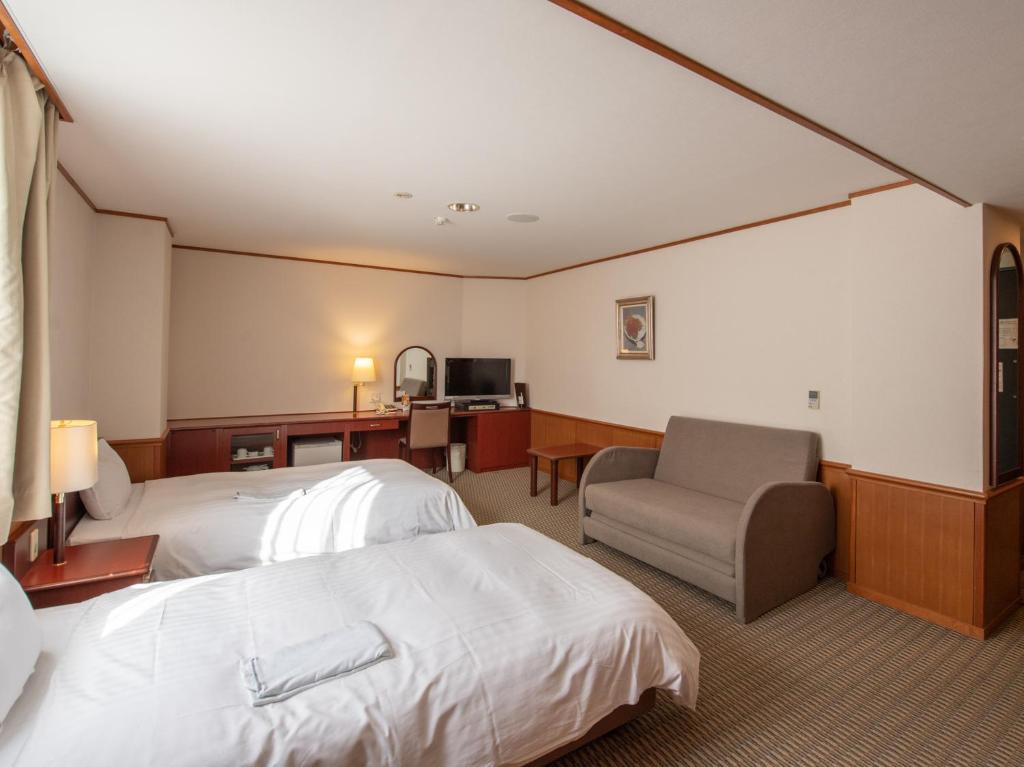 Postel nebo postele na pokoji v ubytování Hotel Iidaya