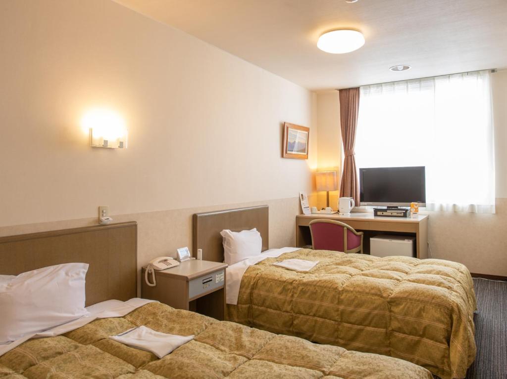 Postel nebo postele na pokoji v ubytování Hotel Iidaya