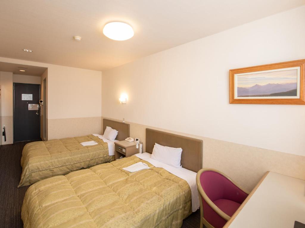 Postel nebo postele na pokoji v ubytování Hotel Iidaya