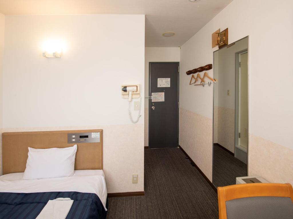 Postel nebo postele na pokoji v ubytování Hotel Iidaya