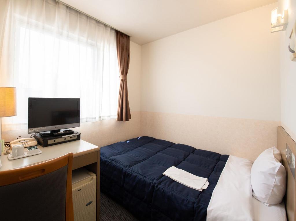 Postel nebo postele na pokoji v ubytování Hotel Iidaya