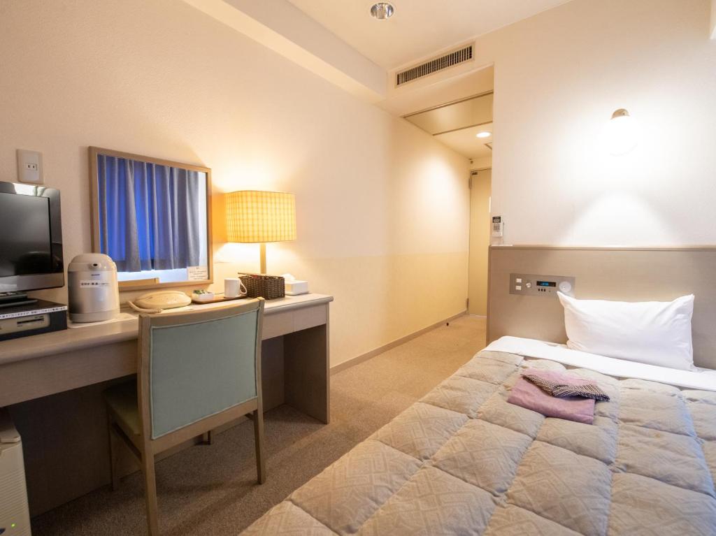 Postel nebo postele na pokoji v ubytování Hotel Iidaya