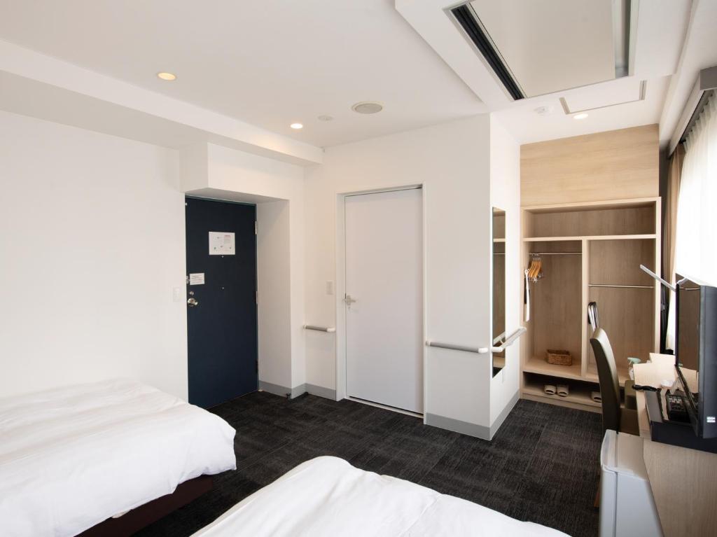 Postel nebo postele na pokoji v ubytování Hotel Iidaya