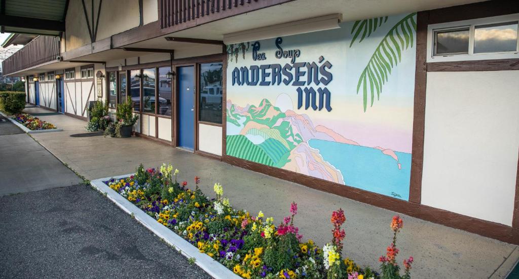a building with a sign on the side of it with flowers at Pea Soup Andersen's Inn in Buellton