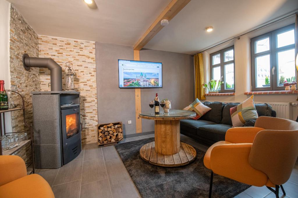 a living room with a couch and a fireplace at Gästehaus am Stadttor in Naumburg