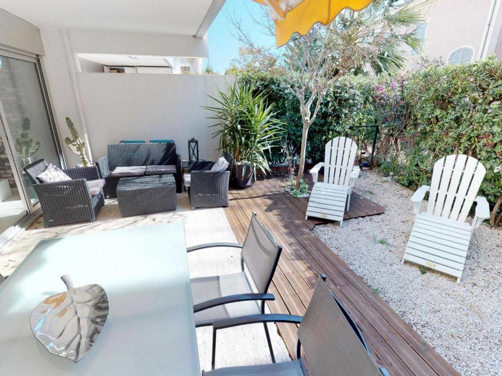 a patio with chairs and a table and a couch at Appartement Menton, 2 pièces, 4 personnes - FR-1-196-164 in Menton