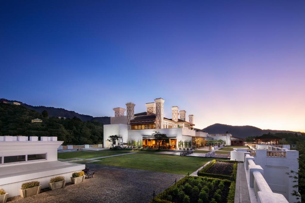 an exterior view of a house with a yard at Jaypee Residency Manor in Mussoorie