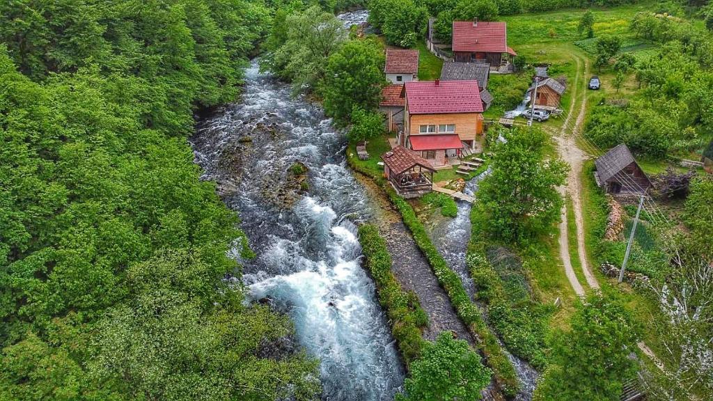 Domacinstvo na kraju svijeta في Šipovo: اطلالة جوية على نهر مع شلال