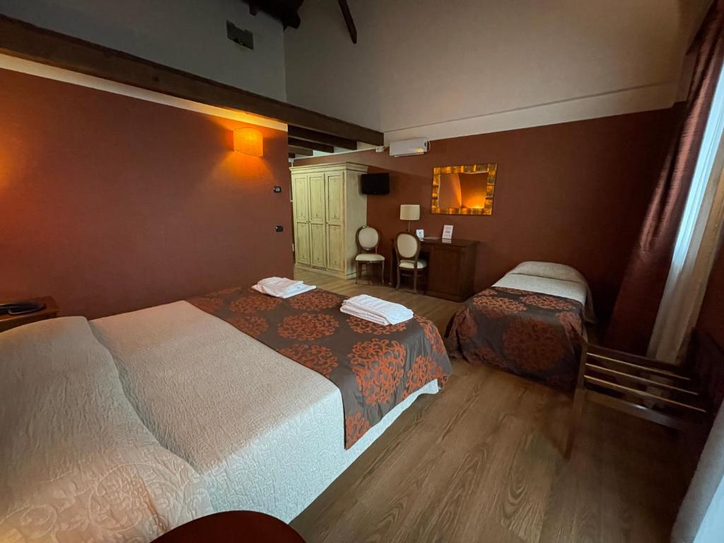 Postel nebo postele na pokoji v ubytování Hotel Cascina Marisa