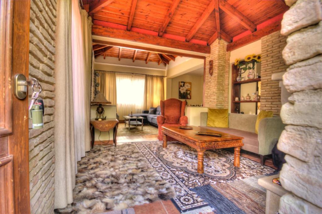 a living room with a couch and a table at Villa Escobadd in Arachova