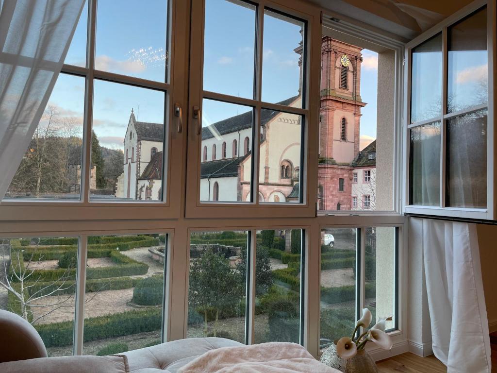 a room with a window looking out at a church at Ferienwohnung St Marien in Gengenbach