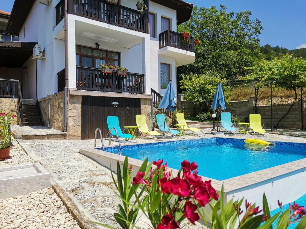 a villa with a swimming pool and a house at Villa Holly in Balchik