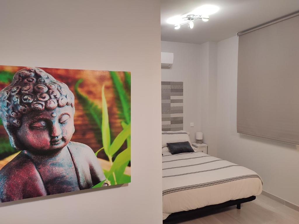 a bedroom with a statue next to a bed at Apartamento Madrid Norte in Madrid